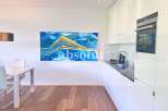 Discover modern living in this stunning property! Featuring a sleek, contemporary kitchen with high-end appliances and ample counter space.