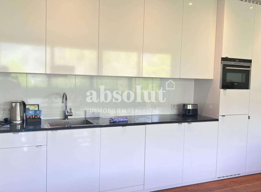 Discover modern living in this stunning kitchen! Featuring sleek white cabinetry and a contemporary design, this space is perfect for culinary enthusiasts.
