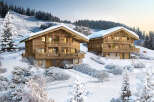Experience the ultimate winter escape in these stunning wooden chalets nestled in a snowy landscape.