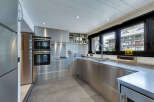 This modern kitchen boasts sleek stainless steel appliances and cabinetry, creating a contemporary and stylish space.