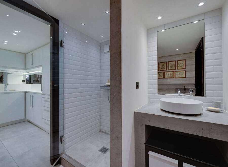 Experience modern luxury in this stunning bathroom featuring a spacious walk-in shower with white subway tiles and a sleek glass enclosure.