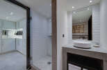 Experience modern luxury in this stunning bathroom featuring a spacious walk-in shower with white subway tiles and a sleek glass enclosure.