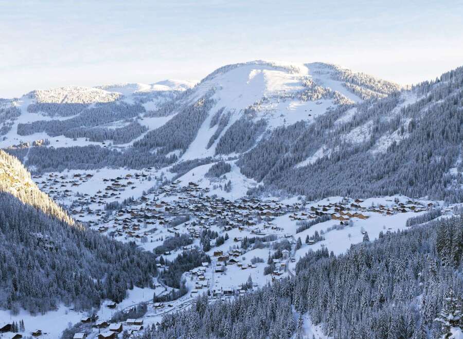 Experience the charm of a snow-covered mountain village nestled in a picturesque valley.