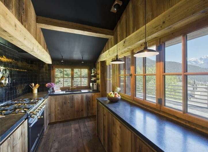 This stunning kitchen boasts a rustic charm with its wooden accents and a sleek black countertop.