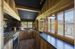 This stunning kitchen boasts a rustic charm with its wooden accents and a sleek black countertop.