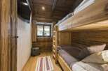 Cozy cabin bedroom featuring rustic wooden bunk beds, perfect for a family getaway.