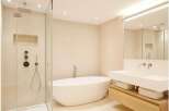 Discover a luxurious bathroom retreat featuring a sleek, modern design.