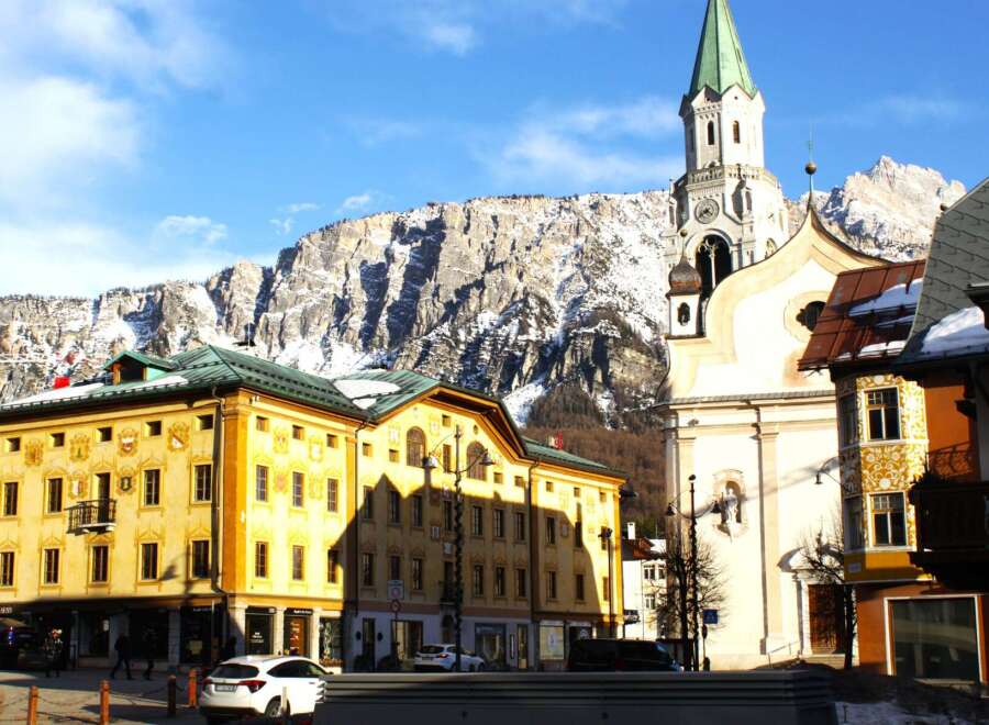 Explore the charming architecture of this European town, featuring a stunning church with a tall steeple.