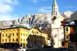 Explore the charming architecture of this European town, featuring a stunning church with a tall steeple.