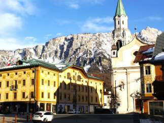 Explore the charming architecture of this European town, featuring a stunning church with a tall steeple.