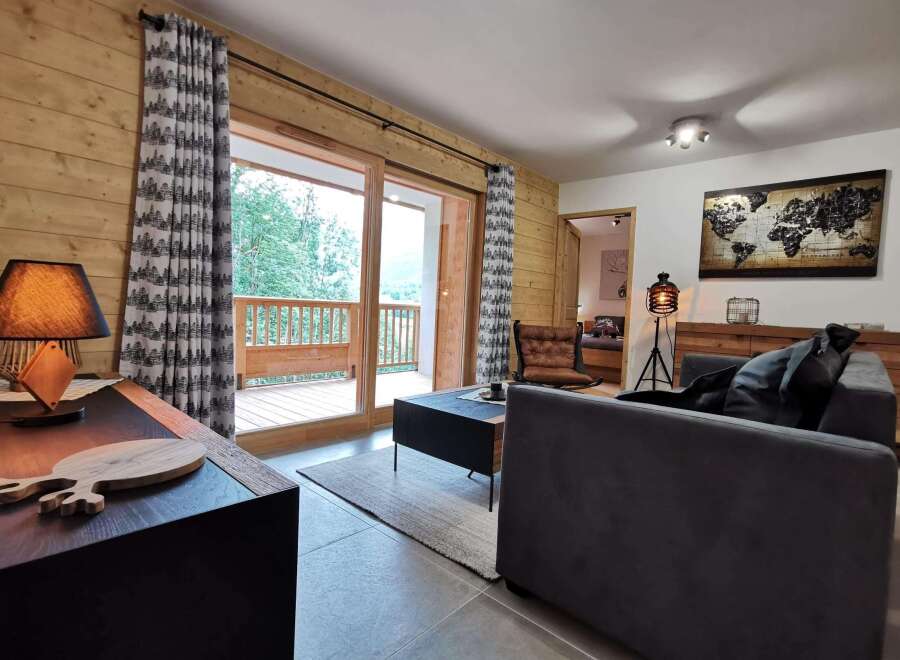 This stunning apartment boasts a spacious living area with floor-to-ceiling windows offering breathtaking views of the surrounding landscape.