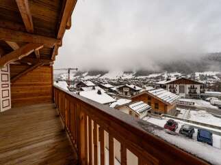 Enjoy breathtaking mountain views from this charming balcony.