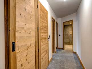 This stunning hallway showcases exquisite wooden doors and a modern design.