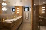 This luxurious bathroom boasts a stunning wooden design, creating a warm and inviting atmosphere.