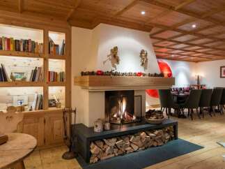 Experience the warmth of this stunning chalet, featuring a cozy fireplace and a beautifully crafted wooden ceiling.