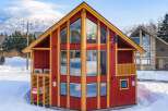 This stunning A-frame chalet boasts expansive windows offering breathtaking mountain views, perfect for a cozy ski retreat.