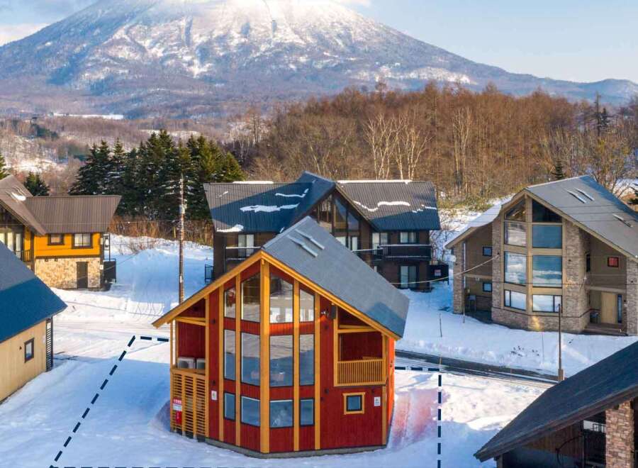 This stunning A-frame chalet boasts breathtaking mountain views and a spacious, open-plan living area with floor-to-ceiling windows.