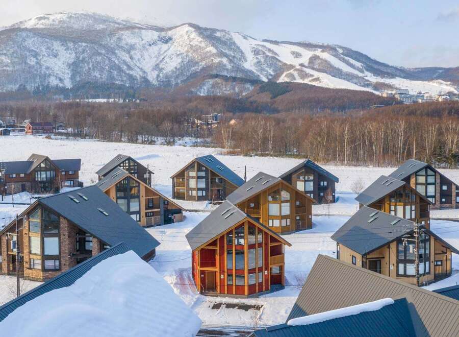 Nestled in a snowy mountainside, this stunning collection of luxury homes offers breathtaking views and unparalleled privacy.