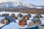 Nestled in a snowy mountainside, this stunning collection of luxury homes offers breathtaking views and unparalleled privacy.