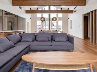 This stunning property boasts an open-concept living area with high ceilings and large windows, creating a bright and airy atmosphere.