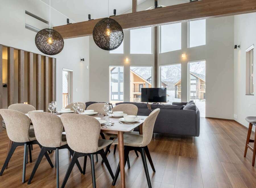 This stunning property boasts an open-plan living area with floor-to-ceiling windows offering breathtaking mountain views.