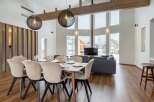 This stunning property boasts an open-plan living area with floor-to-ceiling windows offering breathtaking mountain views.