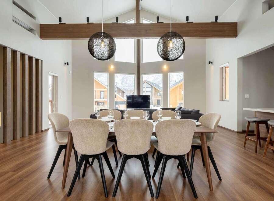 This stunning property boasts a spacious open-plan living area with floor-to-ceiling windows offering breathtaking mountain views.