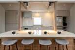 This stunning kitchen boasts a spacious island with seating, perfect for casual dining.