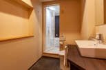 This modern hotel bathroom boasts a sleek, contemporary design with a spacious sink and vanity.
