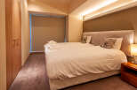 This cozy bedroom features twin beds with crisp white linens, perfect for a relaxing stay.