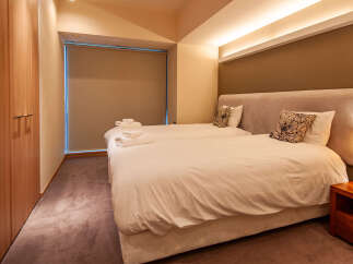 This cozy bedroom features twin beds with crisp white linens, perfect for a relaxing stay.