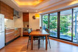 This modern apartment boasts a sleek, open-plan kitchen and dining area, perfect for entertaining.