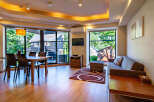 This stunning vacation rental boasts a spacious open-plan living area with floor-to-ceiling windows offering breathtaking views of the surrounding landscape.