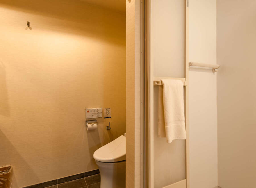 This modern hotel bathroom boasts a sleek, minimalist design with neutral tones.