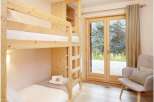 This cozy bedroom features a custom-built bunk bed, perfect for accommodating guests or family.