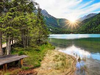 Escape to a serene lakeside retreat surrounded by lush greenery and majestic mountains.