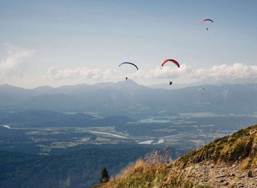 Experience the thrill of paragliding over stunning mountain landscapes.