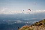 Experience the thrill of paragliding over stunning mountain landscapes.