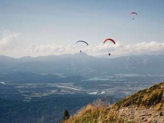 Experience the thrill of paragliding over stunning mountain landscapes.