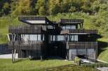 This stunning modern home boasts a unique architectural design with multiple levels and expansive balconies.