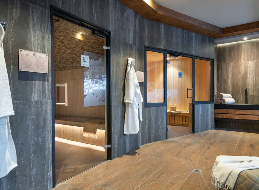 Indulge in tranquility at our luxurious spa, featuring two pristine saunas encased in sleek glass doors.
