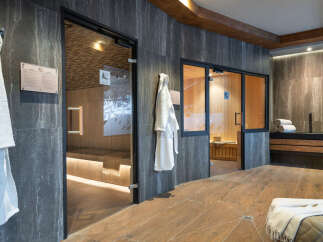 Indulge in tranquility at our luxurious spa, featuring two pristine saunas encased in sleek glass doors.