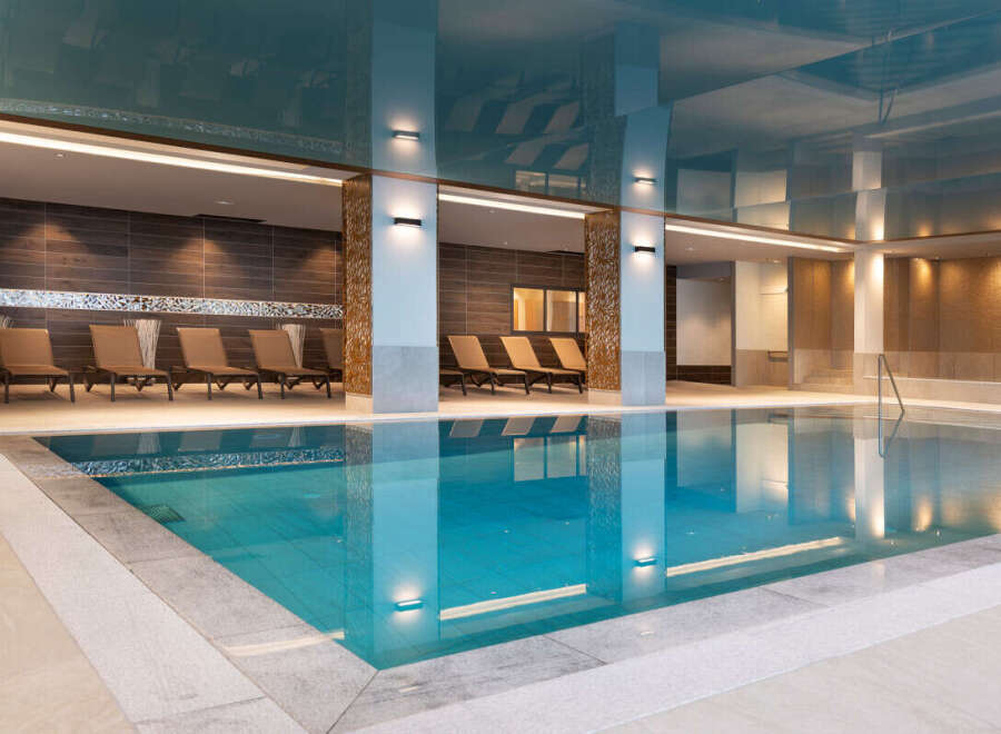 Indulge in tranquility at our luxurious indoor pool, featuring pristine turquoise waters and a sophisticated design.