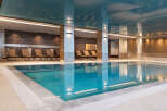 Indulge in tranquility at our luxurious indoor pool, featuring pristine turquoise waters and a sophisticated design.