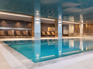 Indulge in tranquility at our luxurious indoor pool, featuring pristine turquoise waters and a sophisticated design.