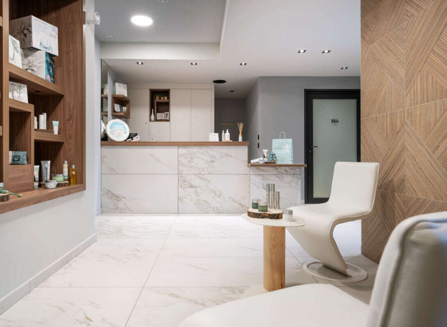 This luxurious spa boasts a sleek, modern design with marble flooring and wooden accents.