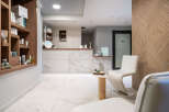 This luxurious spa boasts a sleek, modern design with marble flooring and wooden accents.