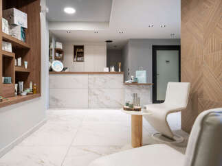 This luxurious spa boasts a sleek, modern design with marble flooring and wooden accents.