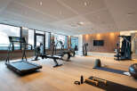 This stunning gym boasts state-of-the-art equipment, including treadmills, rowing machines, and weight machines, perfect for a challenging workout.