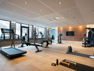 This stunning gym boasts state-of-the-art equipment, including treadmills, rowing machines, and weight machines, perfect for a challenging workout.